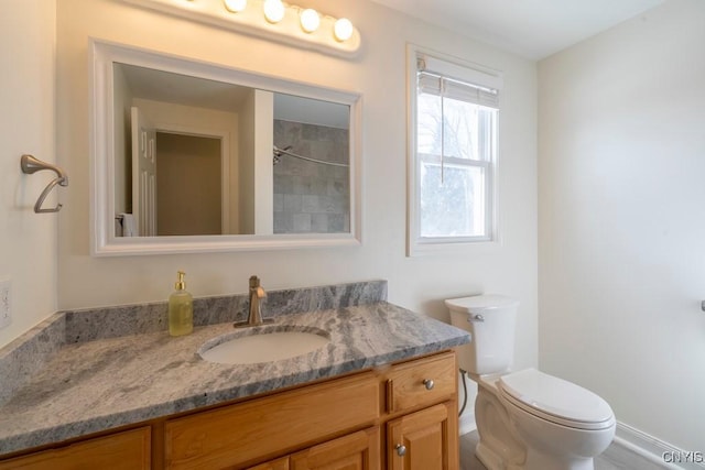 full bathroom with toilet and vanity