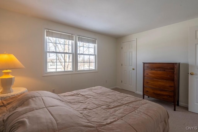 bedroom with carpet and baseboards