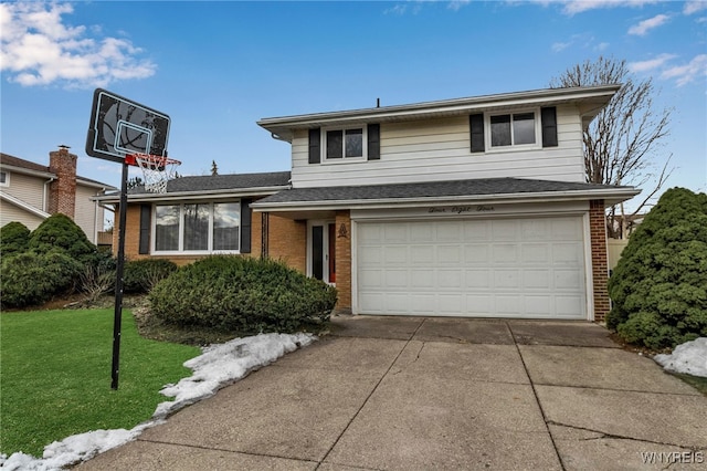 tri-level home featuring brick siding, a garage, driveway, and a front yard