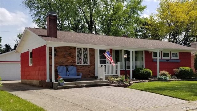 ranch-style house with a front lawn, concrete driveway, roof with shingles, and a chimney