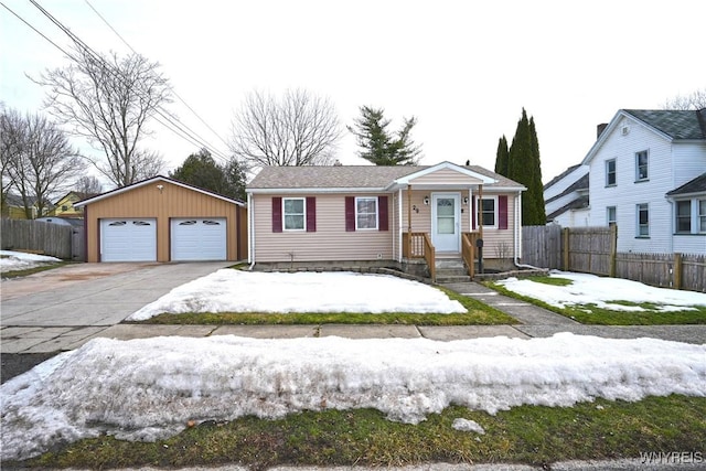 view of front of property featuring an outbuilding, fence, and a garage