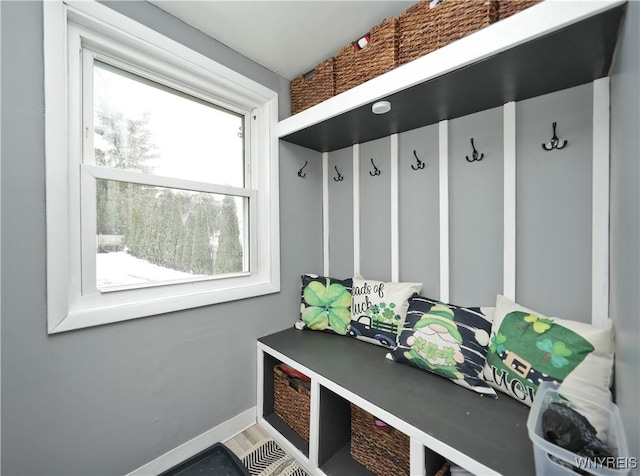 mudroom with wood finished floors and baseboards