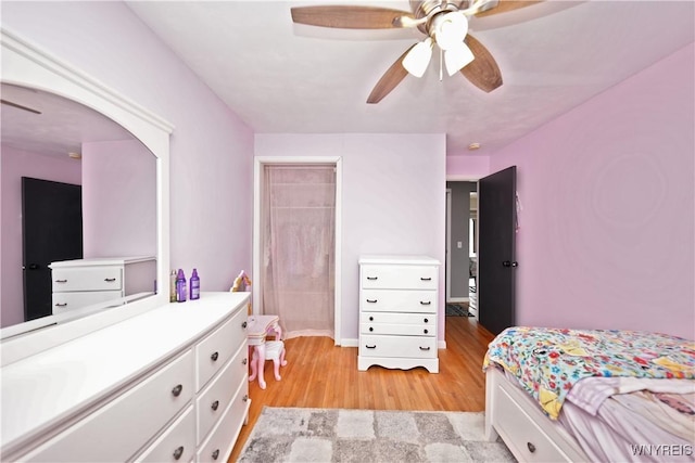 bedroom featuring a closet, light wood-style floors, and ceiling fan