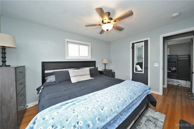 bedroom featuring a ceiling fan, wood finished floors, and baseboards