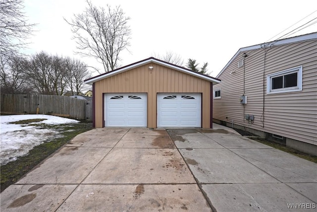 detached garage featuring fence