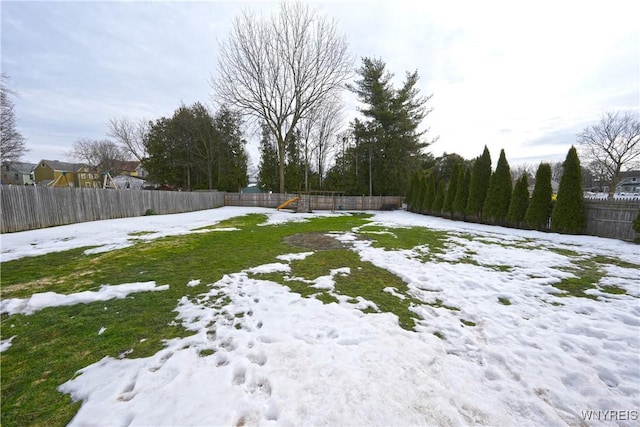 yard covered in snow with fence