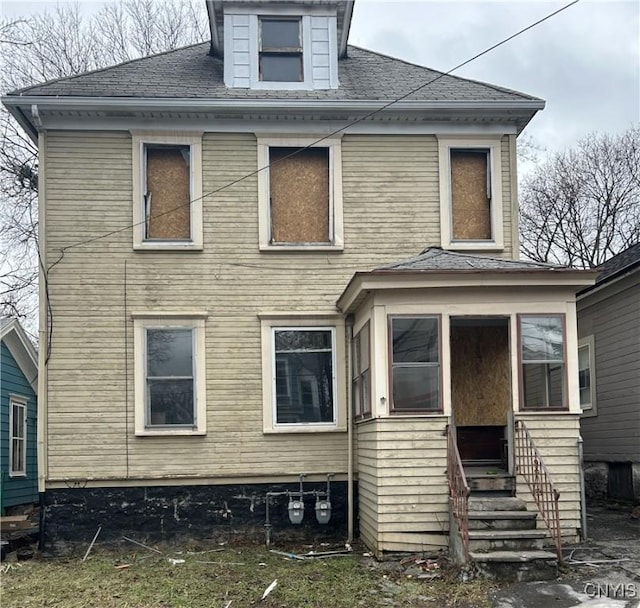 rear view of property with entry steps