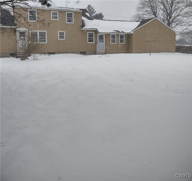 snow covered house with crawl space