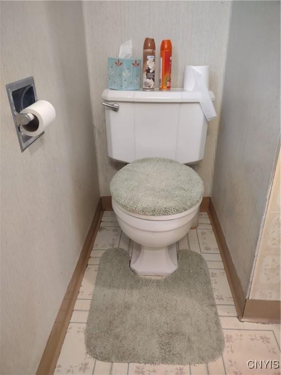 bathroom with baseboards and toilet