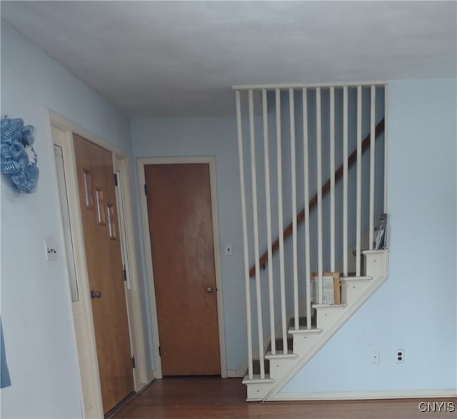 interior space featuring dark wood finished floors and stairway