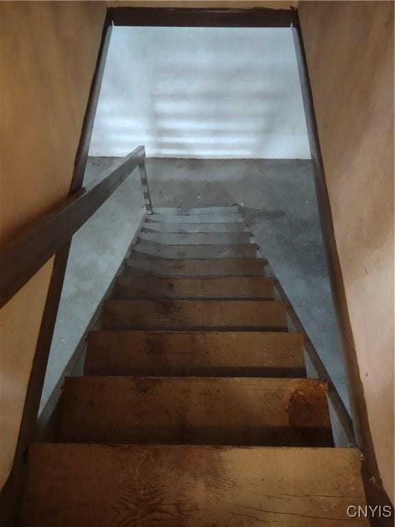 staircase with concrete flooring