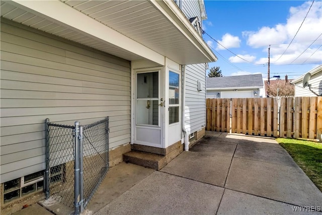 property entrance with a patio area and fence