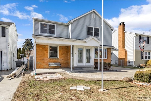 view of front of property with brick siding and french doors