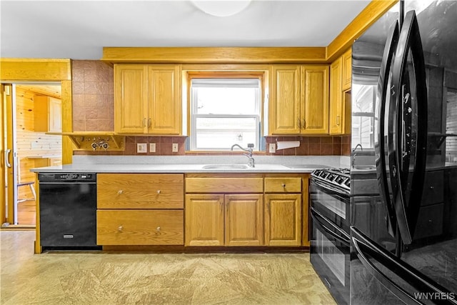 kitchen with a sink, backsplash, black appliances, and light countertops