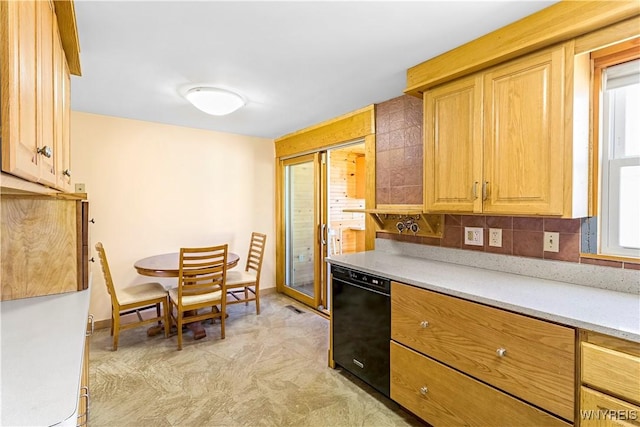 kitchen with tasteful backsplash, dishwasher, light countertops, and baseboards