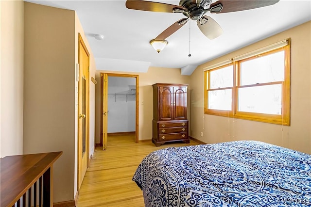 bedroom featuring a closet, light wood-type flooring, and baseboards