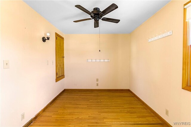 empty room with light wood finished floors, ceiling fan, and baseboards