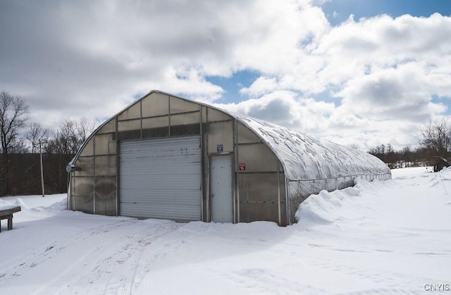 snow covered garage with a garage