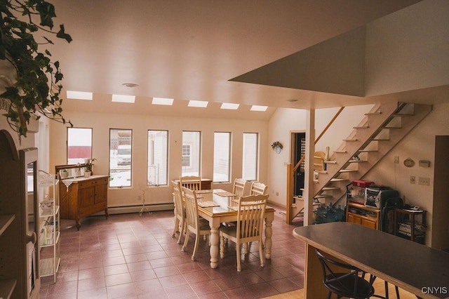 dining room with tile patterned flooring, stairway, and baseboard heating