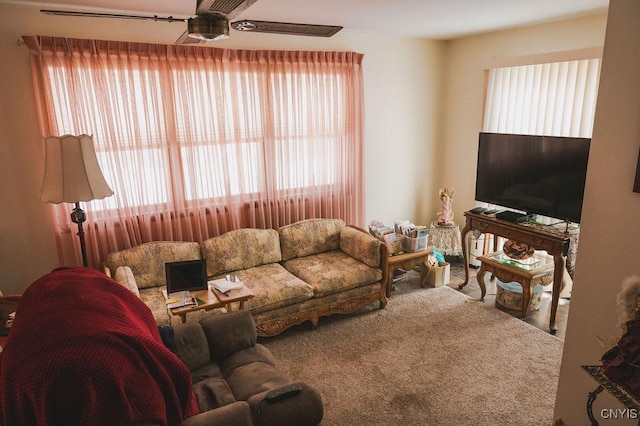 carpeted living room featuring ceiling fan