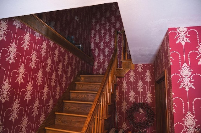 stairway with wallpapered walls