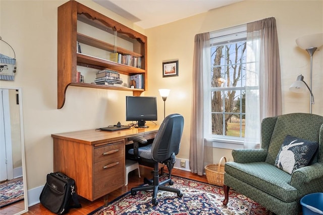 home office featuring baseboards and wood finished floors