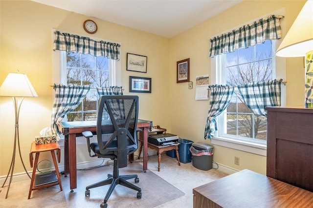 carpeted home office with baseboards