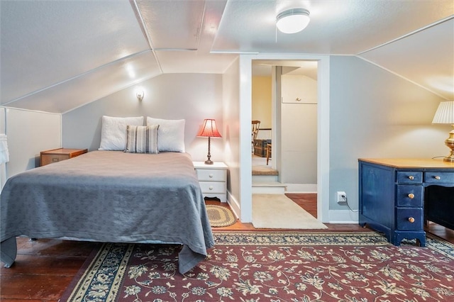 bedroom featuring baseboards and vaulted ceiling