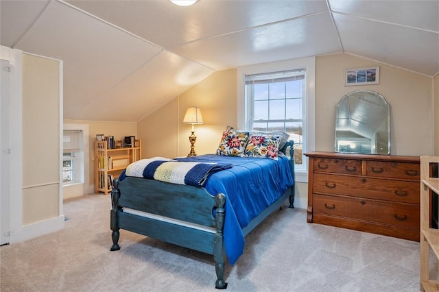 bedroom featuring light carpet, baseboards, and vaulted ceiling