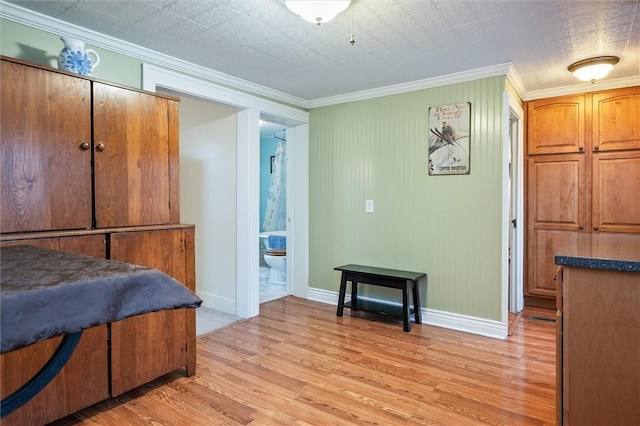 bedroom with light wood-style flooring, baseboards, ensuite bathroom, and ornamental molding