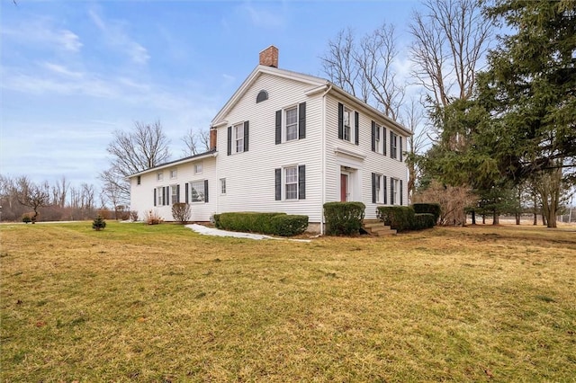 view of property exterior featuring a chimney and a yard