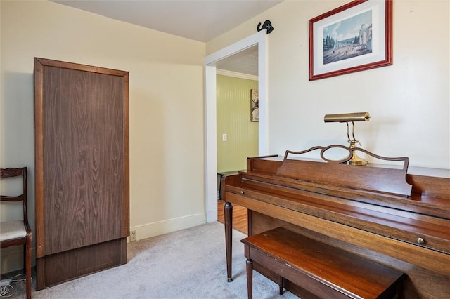 living area with baseboards and light carpet