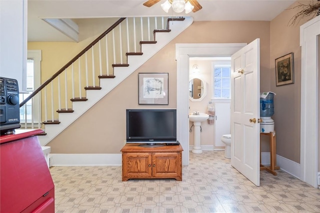 interior space with tile patterned floors, baseboards, and a ceiling fan