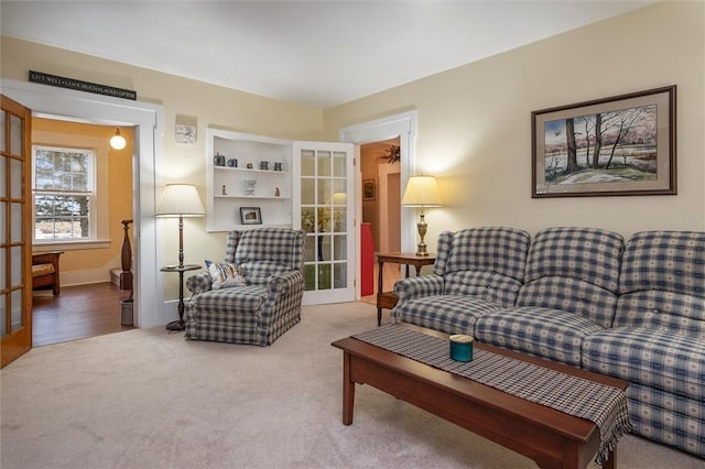 carpeted living room featuring french doors