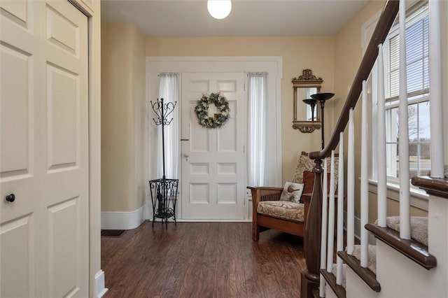 foyer with dark wood finished floors and stairs