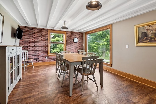 dining space with beam ceiling, wood finished floors, baseboards, and brick wall