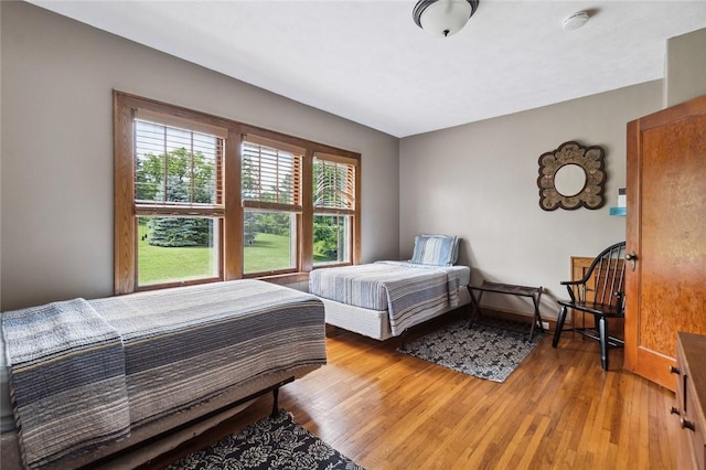 bedroom with baseboards and light wood-type flooring