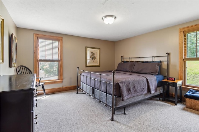 bedroom featuring baseboards and carpet flooring