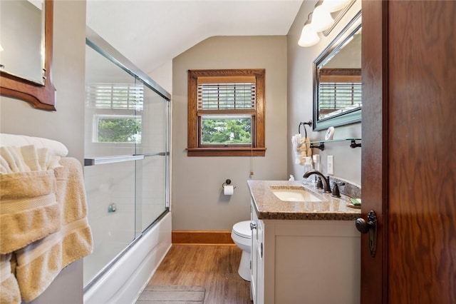 bathroom with vanity, lofted ceiling, wood finished floors, and a wealth of natural light