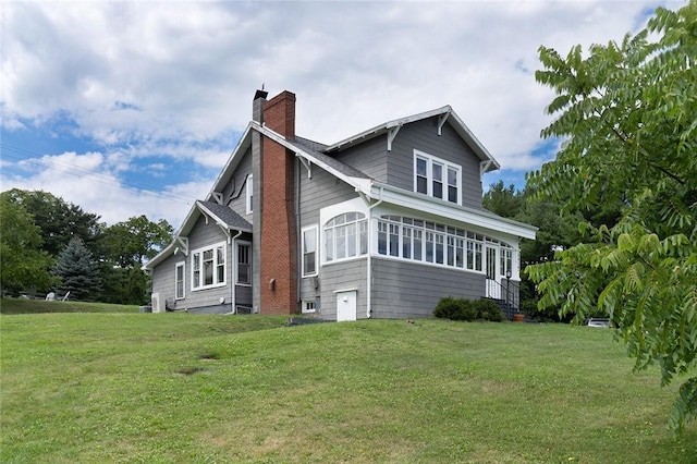 exterior space featuring a lawn and a chimney