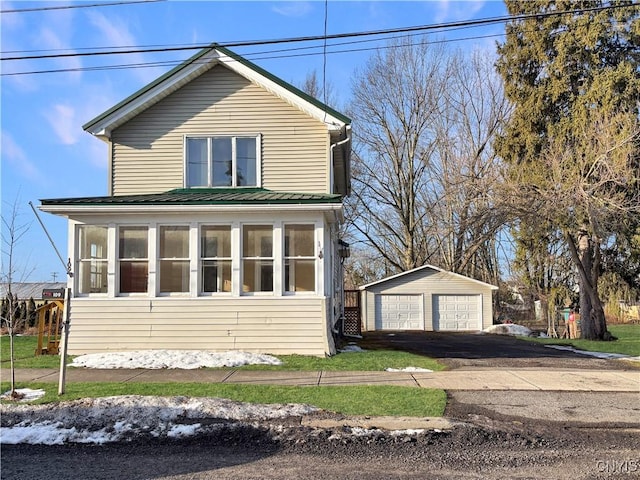 view of front facade with an outbuilding and a garage