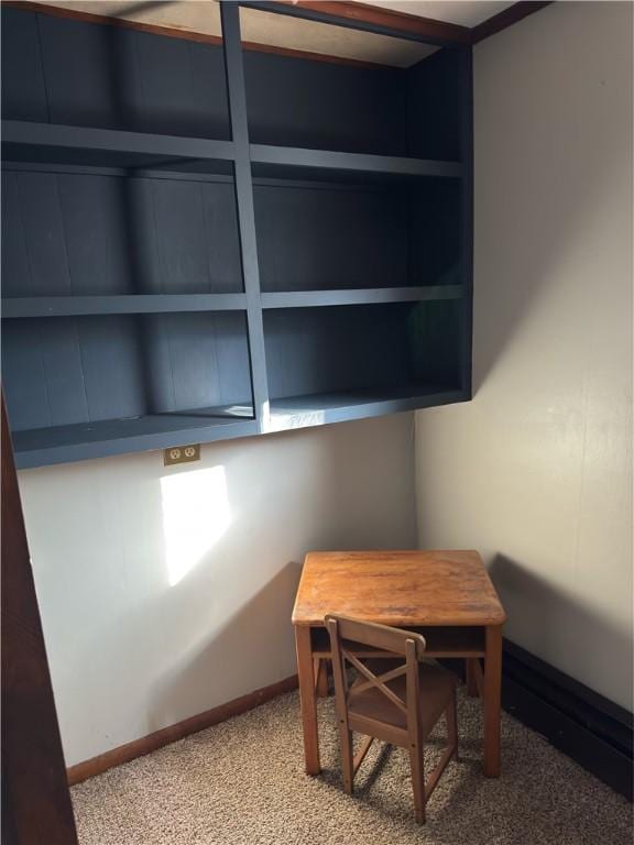 carpeted home office featuring baseboards