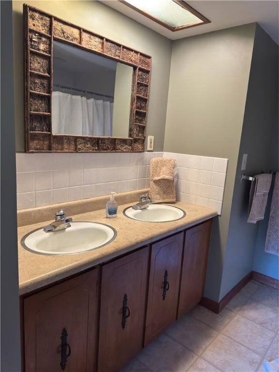 bathroom featuring a sink, backsplash, and double vanity