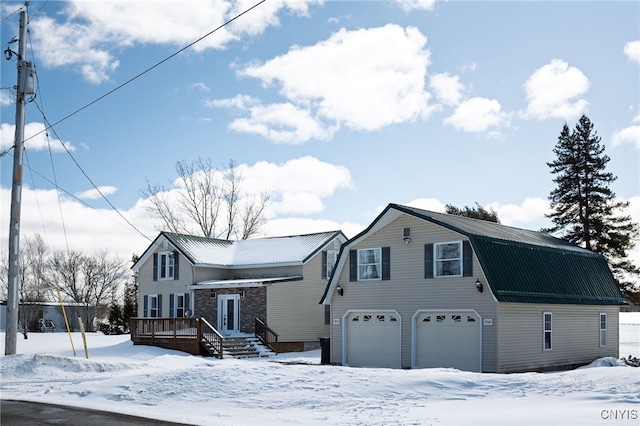 dutch colonial with a wooden deck, a garage, a gambrel roof, and metal roof