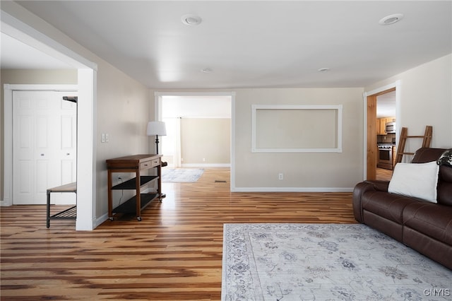 living room with baseboards and wood finished floors