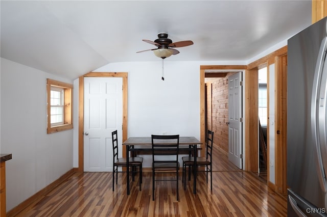 dining room featuring vaulted ceiling, a ceiling fan, and wood finished floors