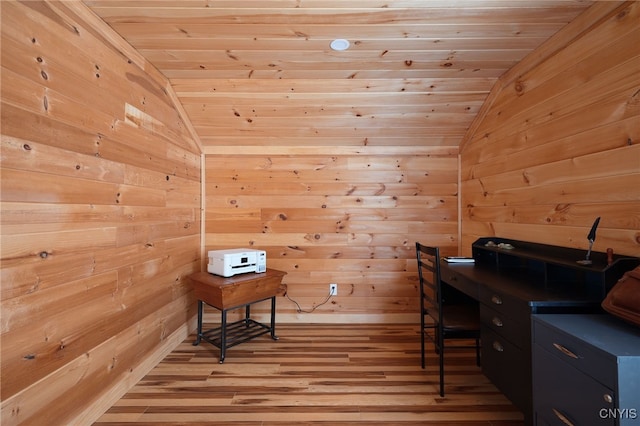 office space with light wood finished floors, wood walls, wood ceiling, and vaulted ceiling