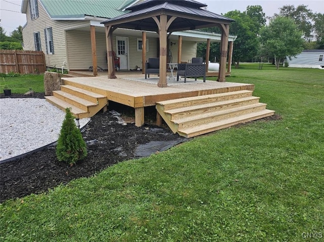 wooden terrace with a lawn and fence