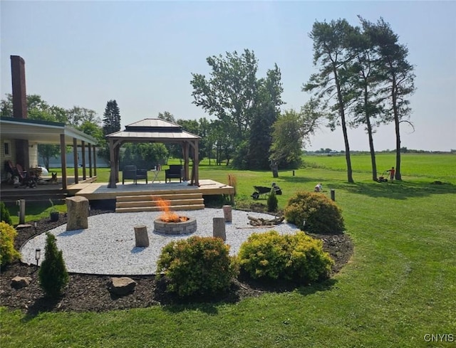 view of home's community with a gazebo, a yard, and a fire pit