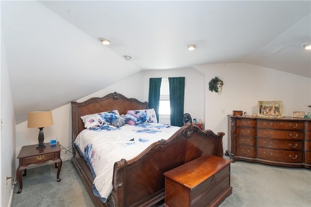 bedroom with light carpet and lofted ceiling